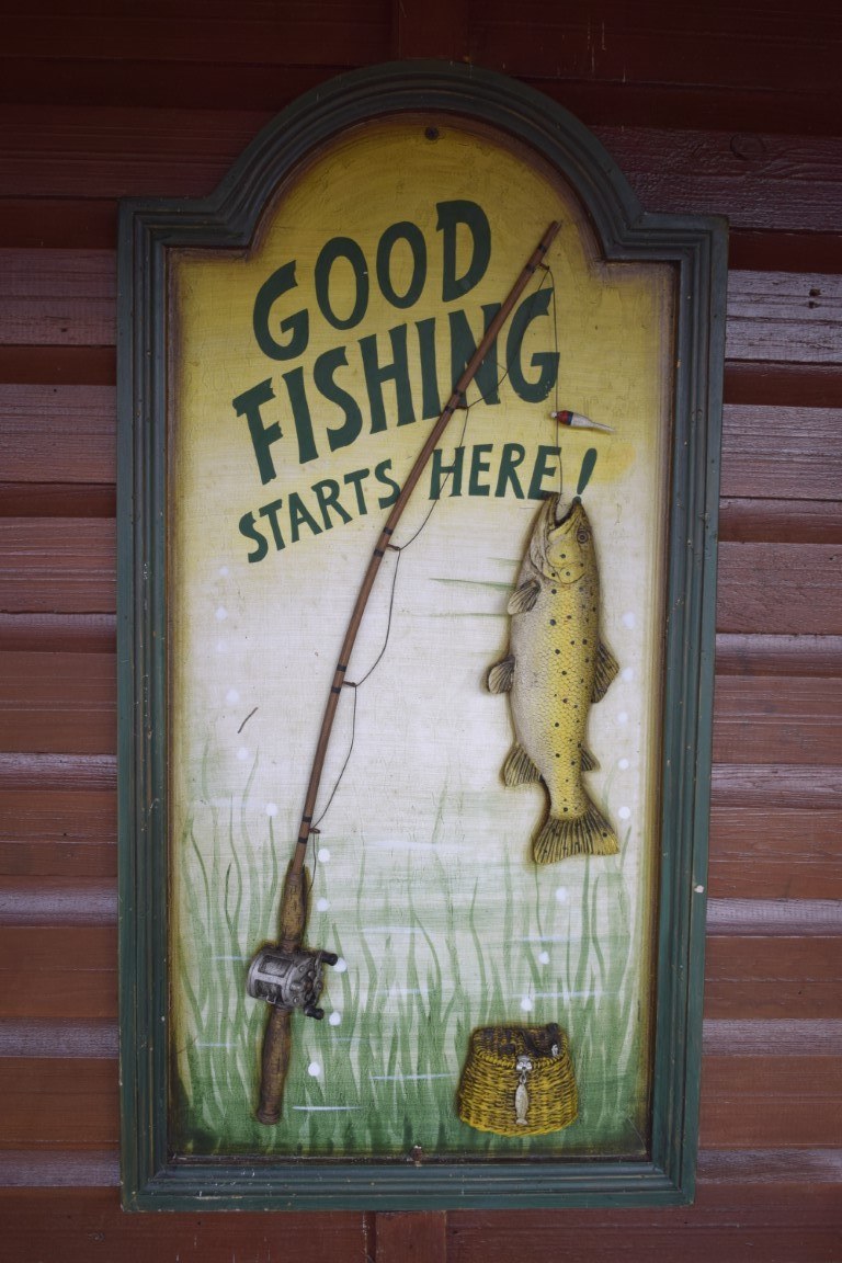 A hand-painted sign on the lodge reading Good Fishing Starts Here