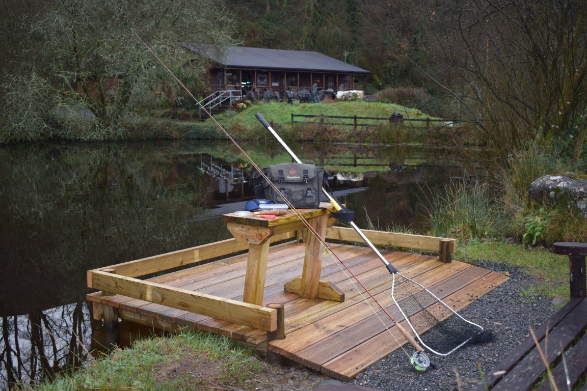 A timber fishing platform at the lake edge