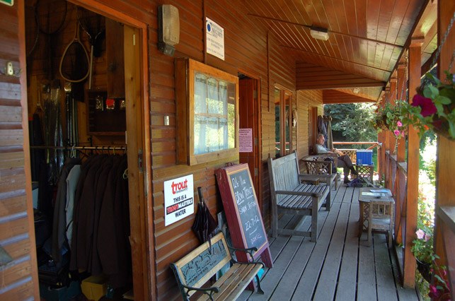 The tackle shop veranda with benches and a chalkboard