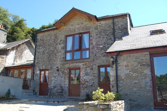 The stone barn holding the apartments, with timber doors and windows