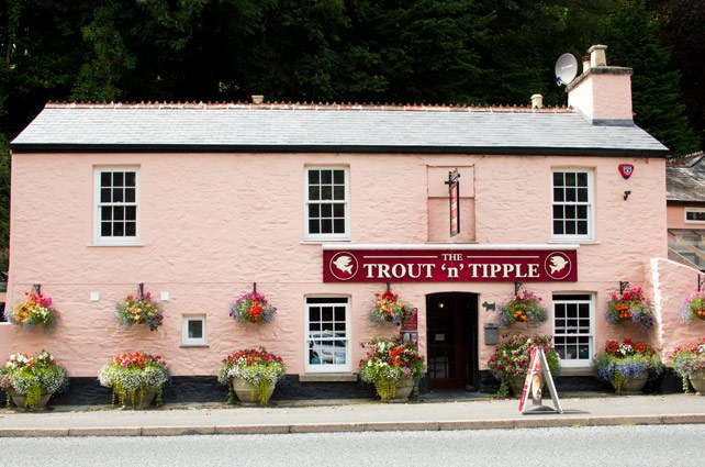The pink-painted Trout ‘n’ Tipple pub with hanging baskets